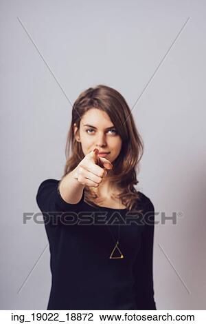 Stock Image - A woman shows a finger forward . Fotosearch