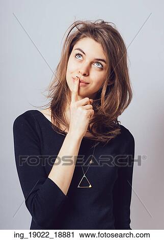 Stock Image - A young pensive girl looking up. Fotosearch