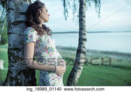 Adorbale pregnant lady touching her belly View Large Photo Image Stock Image - Adorbale pregnant lady touching her belly. Fotosearch