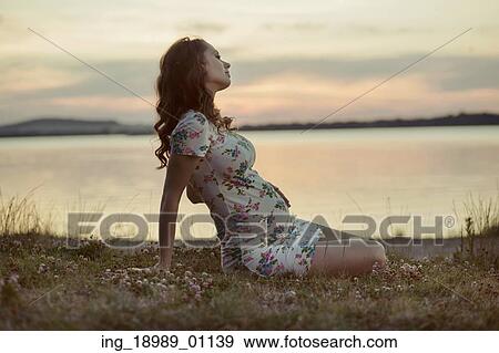 Adorbale pregnant mother resting by the lake View Large Photo Image Stock Photo - Adorbale pregnant mother resting by the lake. Fotosearch