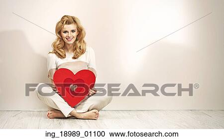 Alluring blonde girl holding red valentine’ s heart View Large Photo Image Stock Image - Alluring blonde girl holding red valentine’ s heart. Fotosearch