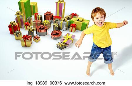 Amazed little boy with lots of gifts View Large Photo Image Stock Photograph - Amazed little boy with lots of gifts. Fotosearch