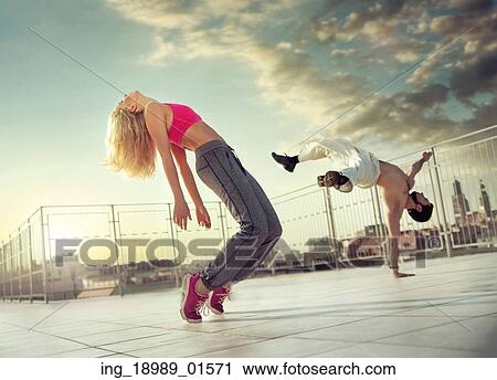 Stock Image - Athletic couple in the miiddle of their training. Fotosearch