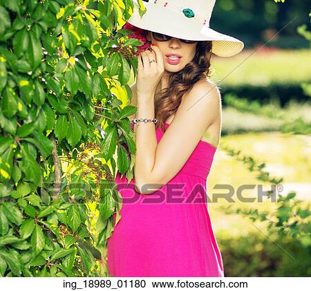 Stock Image - Attractive businesswoman wearing colorful summer stuff. Fotosearch
