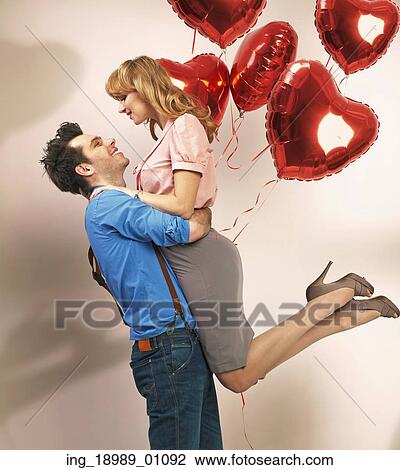 Attractive couple enjoying each other during valentine’ s day View Large Photo Image Stock Image - Attractive couple enjoying each other during valentine’ s day. Fotosearch