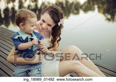 Attractive mom playing with her child View Large Photo Image Stock Image - Attractive mom playing with her child. Fotosearch