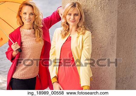 Stock Photo - Attractive women with the colorful umbrellas. Fotosearch