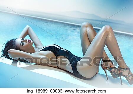 Stock Image - Attractive young cutie with the sea in the background. Fotosearch