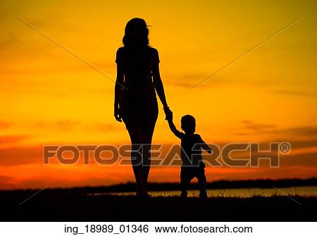 Stock Photograph - Attractive young mother on the walk with baby. Fotosearch