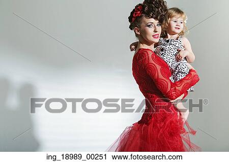 Stock Image - Attractive young mother with cute little daughter. Fotosearch