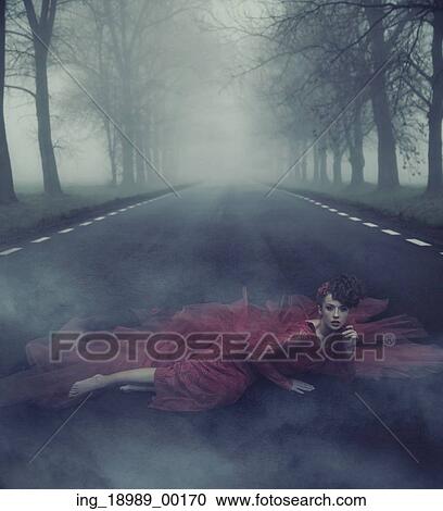 Stock Image - Beautiful elegant lady on a country road. Fotosearch