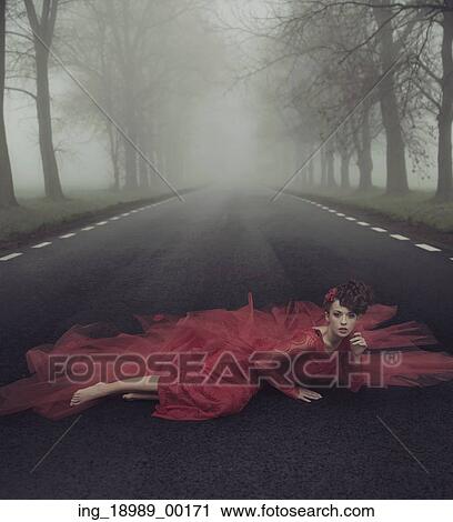 Stock Image - Beautiful elegant lady on a country road. Fotosearch