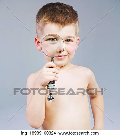 Beautiful little kid looking through a magnifying glass View Large Photo Image Picture - Beautiful little kid looking through a magnifying glass. Fotosearch