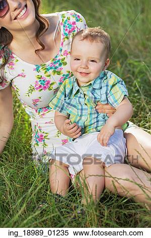 Stock Photography - Beautiful mom with relaxed baby son. Fotosearch