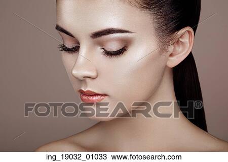 Stock Image - Beautiful woman face. Perfect makeup. Beauty fashion. Eyelashes. Cosmetic Eyeshadow. Highlighting. Fotosearch