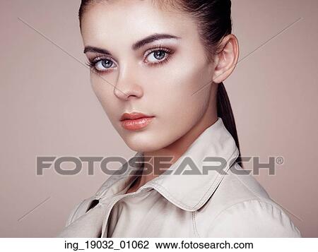 Stock Image - Beautiful woman face. Perfect makeup. Beauty fashion. Eyelashes. Cosmetic Eyeshadow. Highlighting. Fotosearch