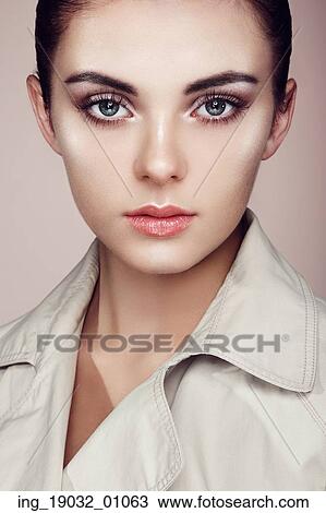 Stock Image - Beautiful woman face. Perfect makeup. Beauty fashion. Eyelashes. Cosmetic Eyeshadow. Highlighting. Fotosearch