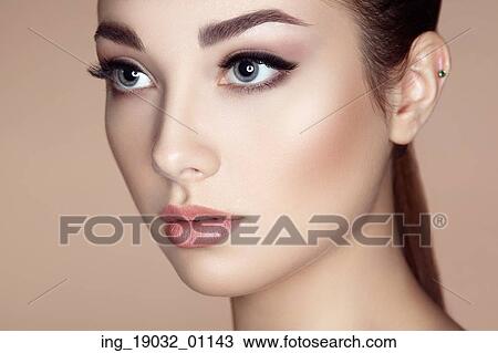 Stock Image - Beautiful woman face. Perfect makeup. Beauty fashion. Eyelashes. Lips. Cosmetic Eyeshadow. Fotosearch