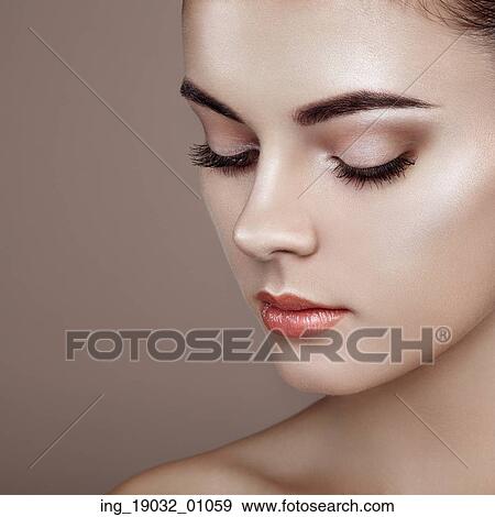 Stock Photo - Beautiful woman face. Perfect makeup. Beauty fashion. Eyelashes. Cosmetic Eyeshadow. Highlighting. Fotosearch