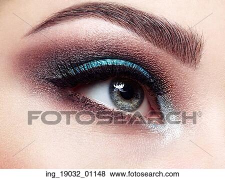 Stock Photo - Beautiful woman face. Perfect makeup. Beauty fashion. Eyelashes. Lips. Cosmetic Eyeshadow. Make-up detail. Eyeliner. Fotosearch