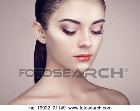 Stock Photo - Beautiful woman face. Perfect makeup. Beauty fashion. Eyelashes. Cosmetic Eyeshadow. Highlighting. Fotosearch