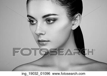 Stock Photograph - Beautiful woman face. Perfect makeup. Beauty fashion. Eyelashes. Cosmetic Eyeshadow. Highlighting. Black and white. Fotosearch