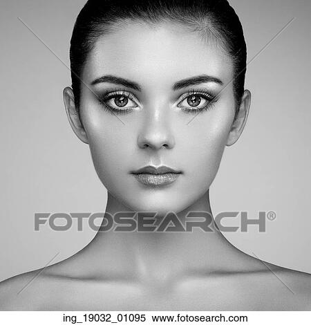 Stock Photography - Beautiful woman face. Perfect makeup. Beauty fashion. Eyelashes. Cosmetic Eyeshadow. Highlighting. Black and white. Fotosearch