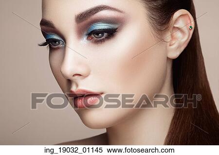 Stock Photography - Beautiful woman face. Perfect makeup. Beauty fashion. Eyelashes. Lips. Cosmetic Eyeshadow. Fotosearch