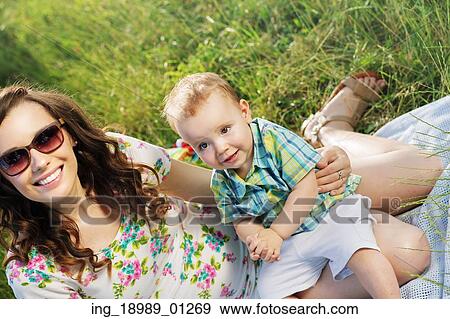 Stock Photo - Beautiful woman with her cute little son. Fotosearch
