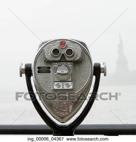 Stock Photo - Binoculars looking towards the Statue of Liberty, Ellis Island, Jersey City, New York State, USA. Fotosearch