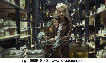 Stock Image - Blond attractive lady in the retro laboratory. Fotosearch