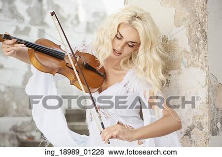 Stock Photo - Blond cute woman playing the violin. Fotosearch