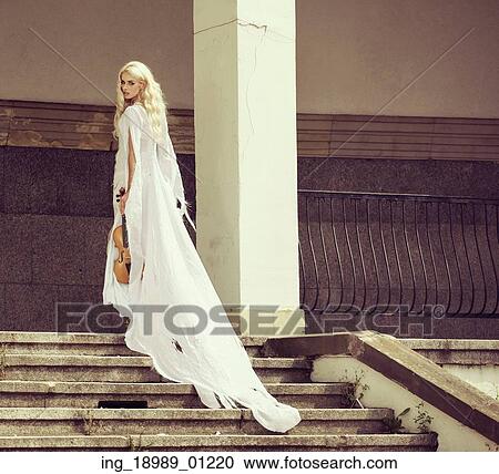 Stock Image - Blond woman with the old violin. Fotosearch