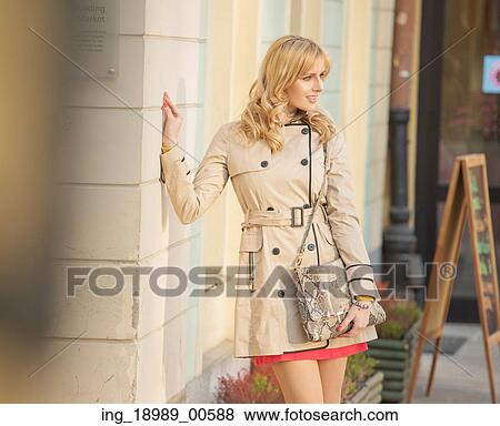 Stock Photo - Blonde girl posing next to the old building. Fotosearch