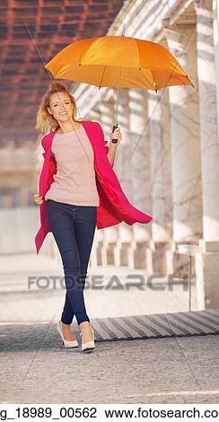 Blonde lady with the orange umbrella View Large Photo Image Stock Image - Blonde lady with the orange umbrella. Fotosearch