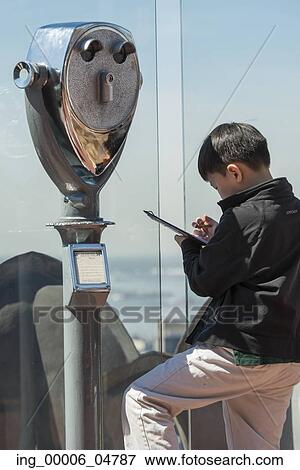 Stock Photo - Boy at the Top of the Rock observation deck, Midtown Manhattan, New York City, New York State, USA. Fotosearch