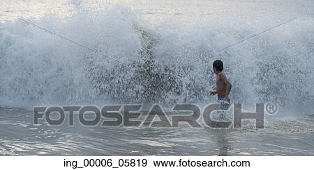 Boy running in waves on beach, Zihuatanejo, Guerrero, Mexico View Large Photo Image Stock Photo - Boy running in waves on beach, Zihuatanejo, Guerrero, Mexico. Fotosearch
