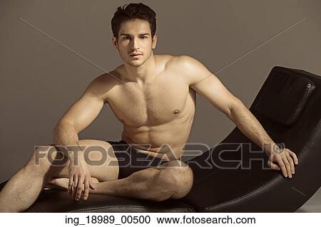 Stock Image - Brunette guy relaxing after gym. Fotosearch