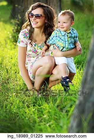 Stock Photography - Brunette mom with her lovely kid. Fotosearch