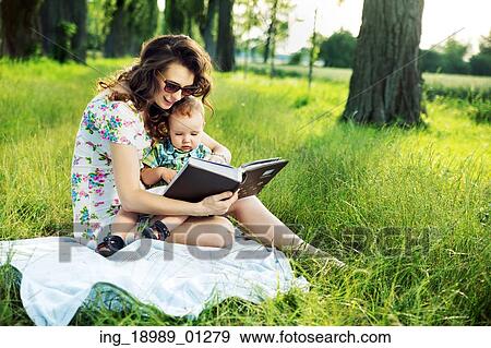 Brunette mother reading a fairy tale for her kid View Large Photo Image Stock Photo - Brunette mother reading a fairy tale for her kid. Fotosearch