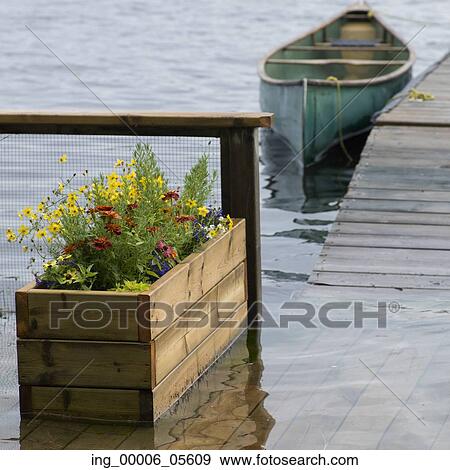 Stock Photo - Canoe moored at dock, Lake Of The Woods, Ontario, Canada. Fotosearch