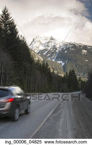 Stock Photography - Car moving on the road through mountains, Whistler, British Columbia, Canada. Fotosearch