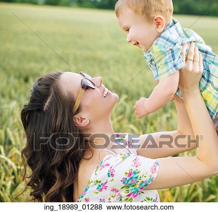 Stock Photo - Charming young mother with little child. Fotosearch