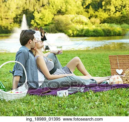 Cheerful couple resting in the park View Large Photo Image Stock Photography - Cheerful couple resting in the park. Fotosearch
