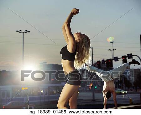 Stock Photography - Cheerful couple training in the middle of the city. Fotosearch
