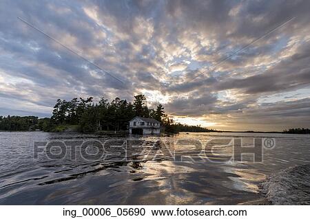 Clouds over a lake during sunset, Lake of the Woods, Ontario, Canada View Large Photo Image Stock Image - Clouds over a lake during sunset, Lake of the Woods, Ontario, Canada. Fotosearch