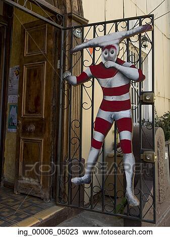 Clown hanging from a wrought iron door, Valparaiso, Chile View Large Photo Image Stock Image - Clown hanging from a wrought iron door, Valparaiso, Chile. Fotosearch