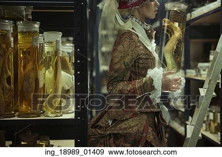 Conceptual potrait of the woman in the retro laboratory View Large Photo Image Stock Photo - Conceptual potrait of the woman in the retro laboratory. Fotosearch