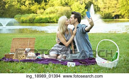 Couple making the kissing selfie photo View Large Photo Image Picture - Couple making the kissing selfie photo. Fotosearch