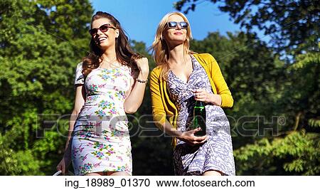 Couple of attractive girlfriends on the walk in the park View Large Photo Image Stock Image - Couple of attractive girlfriends on the walk in the park. Fotosearch
